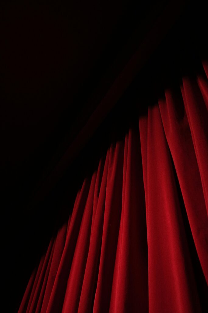 pexels-photo-4722571-4722571 A striking red velvet curtain with dramatic lighting in a theater setting, offering ample copy space.