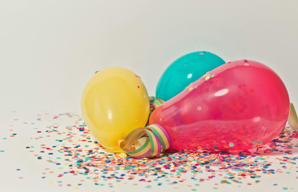 pexels-photo-796606-796606 Vibrant colorful balloons surrounded by confetti, perfect for party celebrations.